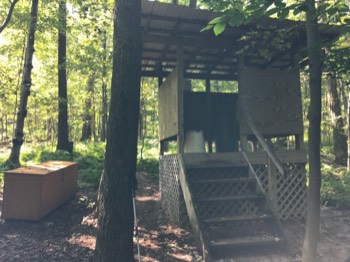  Privy faces away from shelter 